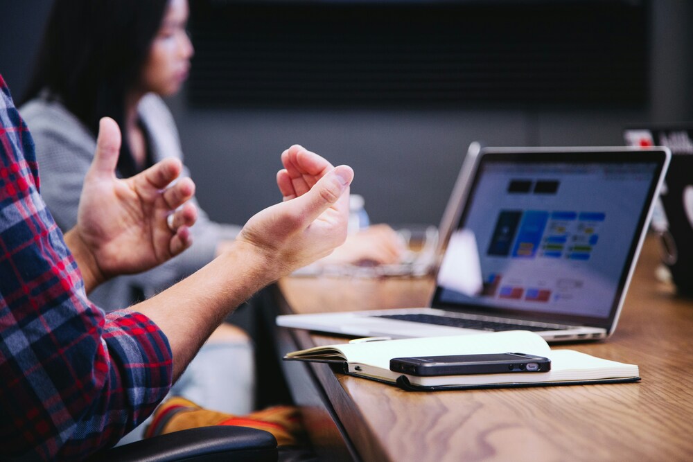 Business owner discussing an acquisition with a potential buyer during a meeting.